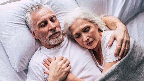 Senior couple laying in bed