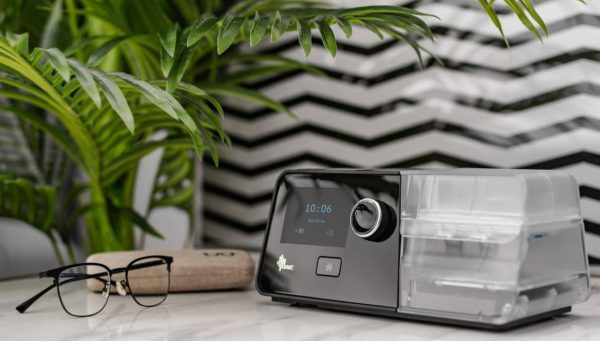 BMC CPAP Machine and glasses on table | CPAP.co.uk